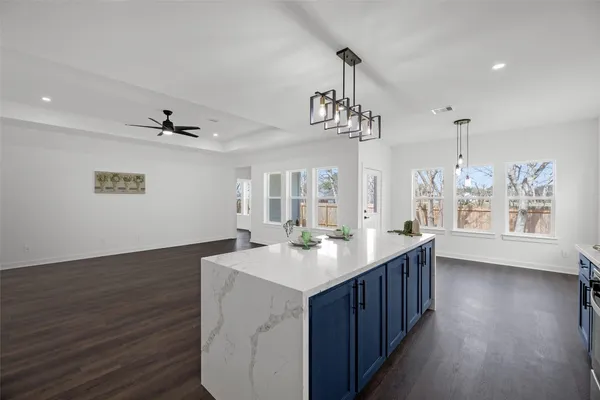 a kitchen with wooden floor and window