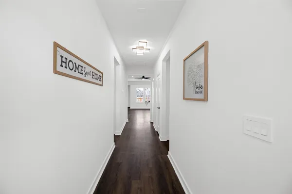 a view of a hallway with wooden floor