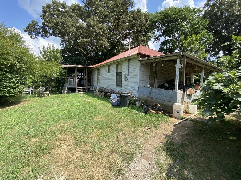 a view of backyard of house with seating space