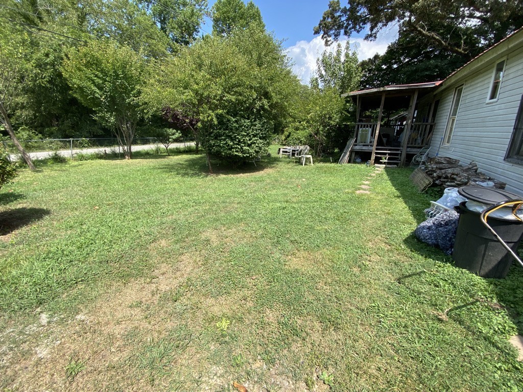 504 North 2nd Street Decherd, TN 37324 - Photo 2 of 2 a view of backyard with table and chairs and potted plants and large trees