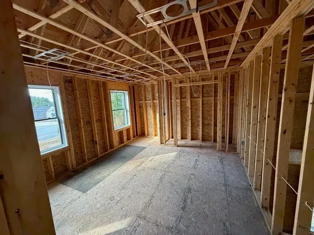 a view of hallway with wooden door and a wooden floors