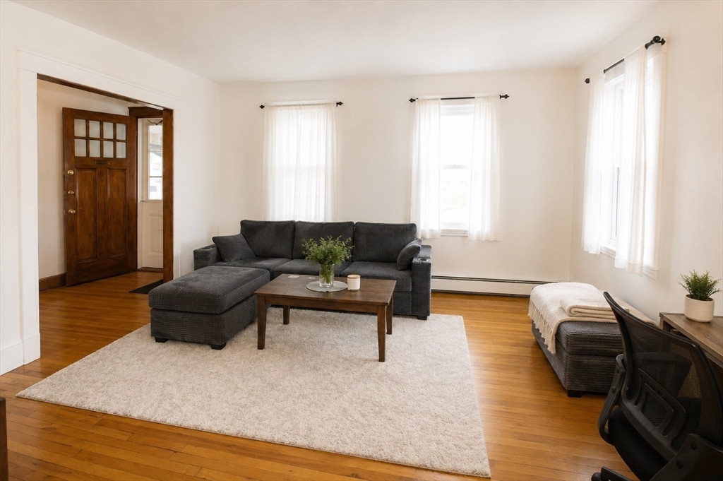 15 Herbert Road, Unit 15 Arlington, MA 02474 - Photo 3 of 9 a living room with furniture and a wooden floor