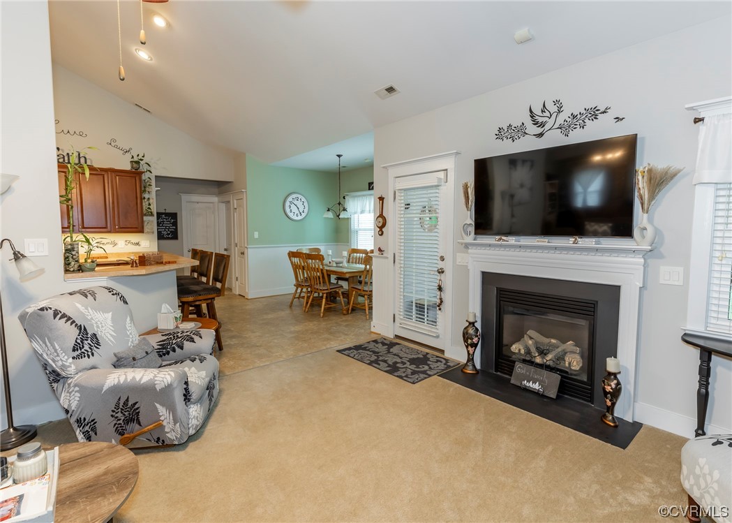 337 Shelton Place Aylett, VA 23009 - Photo 15 of 34 a living room with furniture a flat screen tv and a fireplace