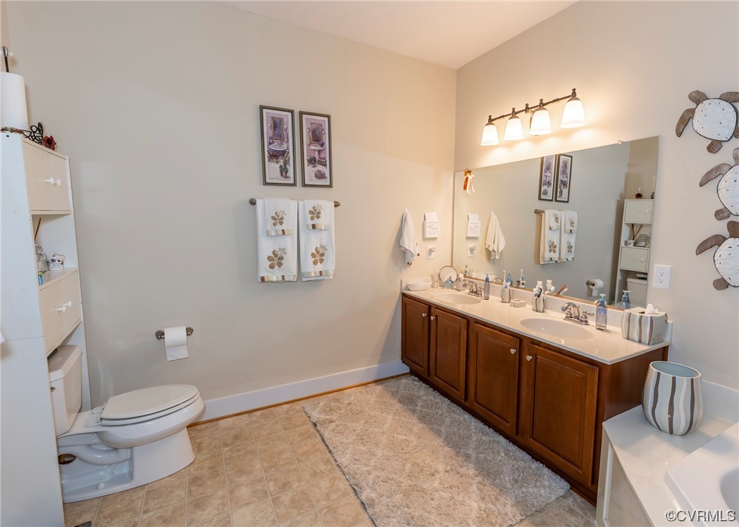 337 Shelton Place Aylett, VA 23009 - Photo 23 of 34 a spacious bathroom with a toilet sink and mirror