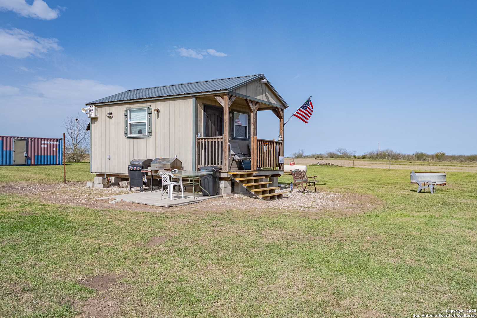 1061 County Road 156 Kenedy, TX 78119 - Photo 26 of 34 a view of a backyard with table and chairs and potted plants