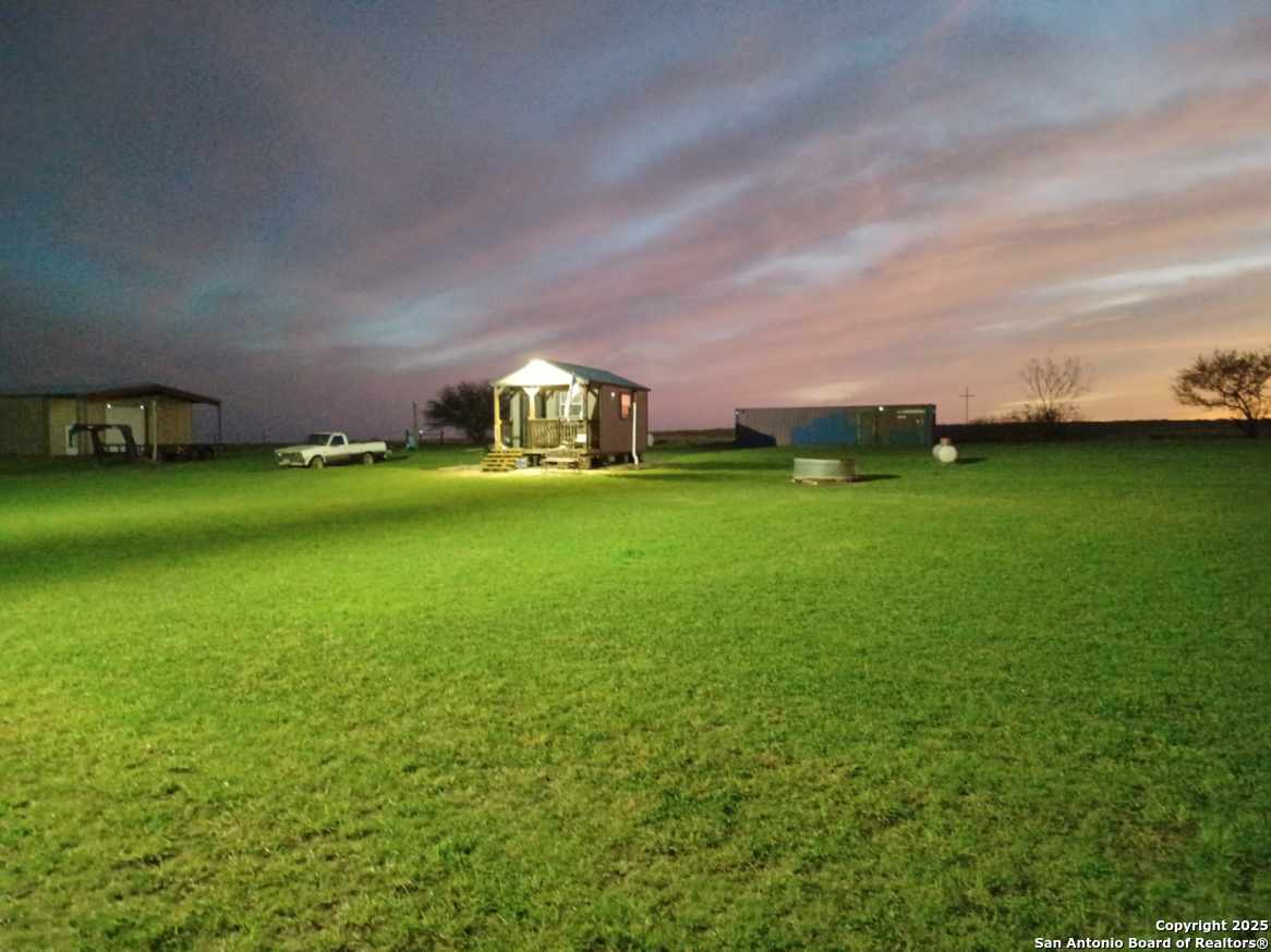 1061 County Road 156 Kenedy, TX 78119 - Photo 3 of 34 a view of a big room with a big yard and large trees