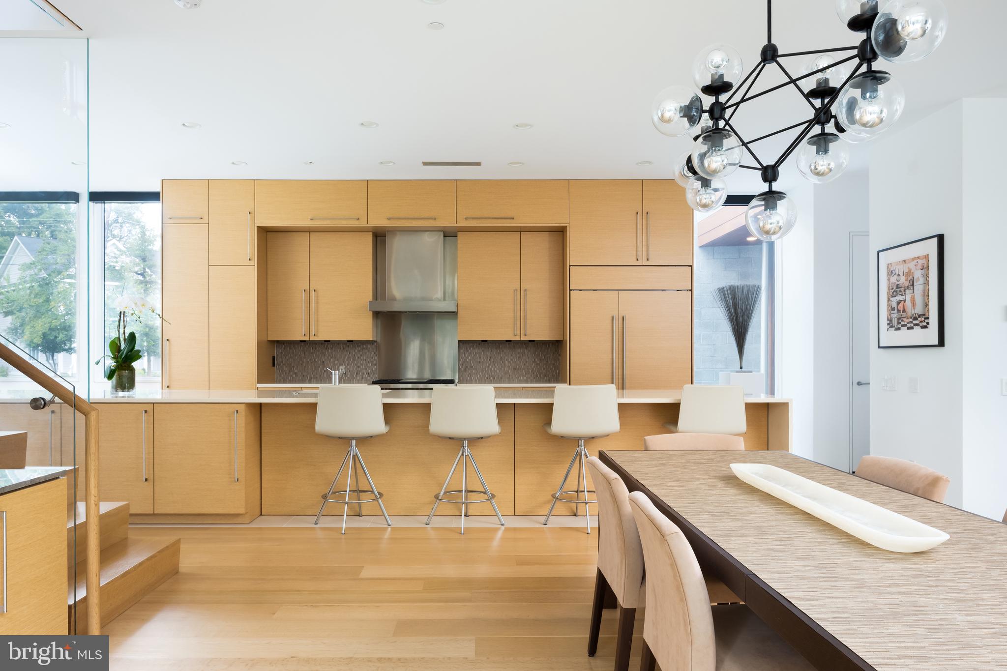 9119 Levelle Drive Chevy Chase, MD 20815 - Photo 15 of 48 a kitchen with a table chairs and wooden floor