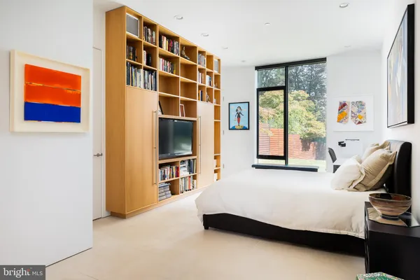 a bedroom with a bed and flat screen tv