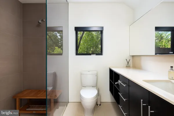 a bathroom with a toilet a sink and a mirror