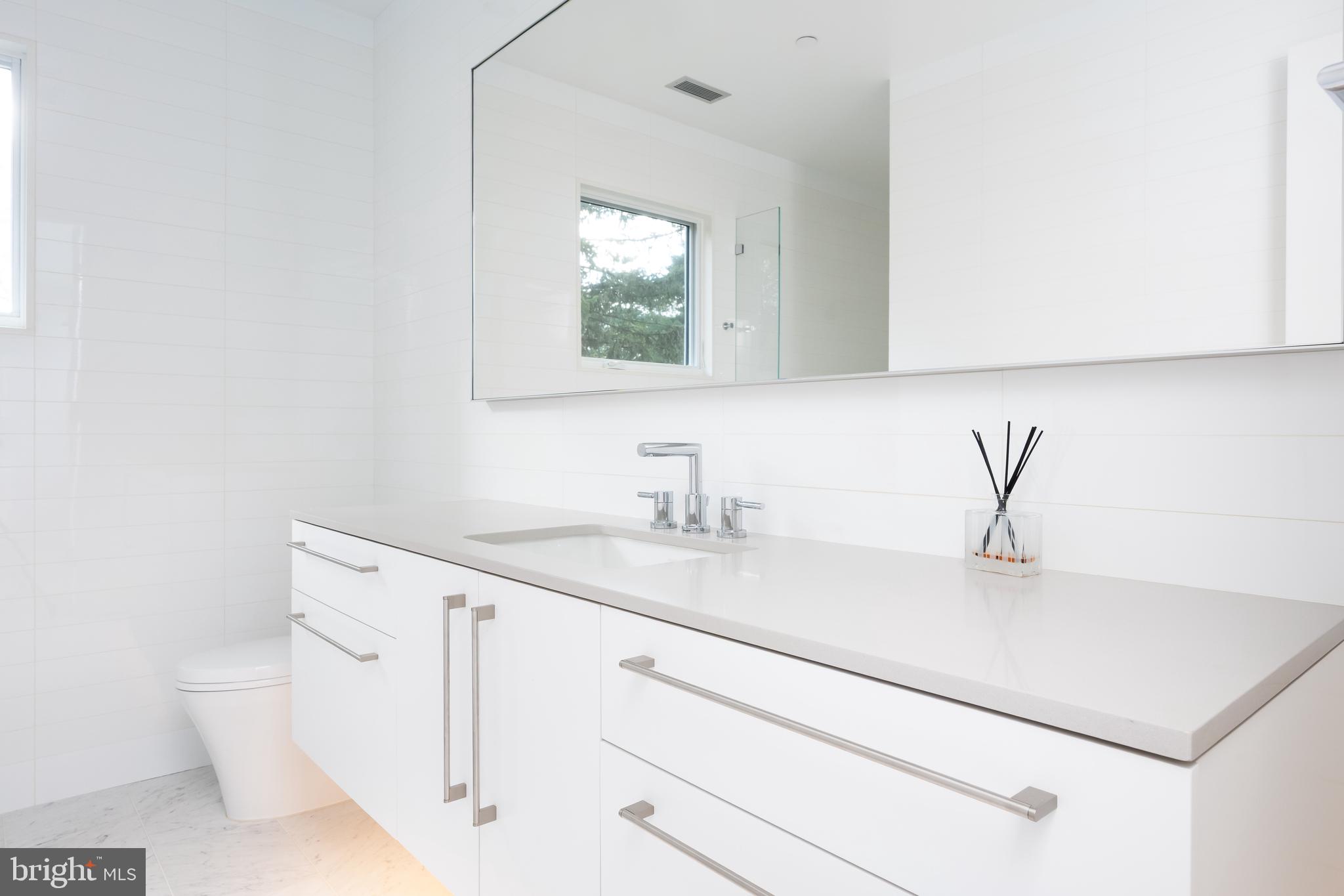 9119 Levelle Drive Chevy Chase, MD 20815 - Photo 25 of 48 a bathroom with a sink and a mirror
