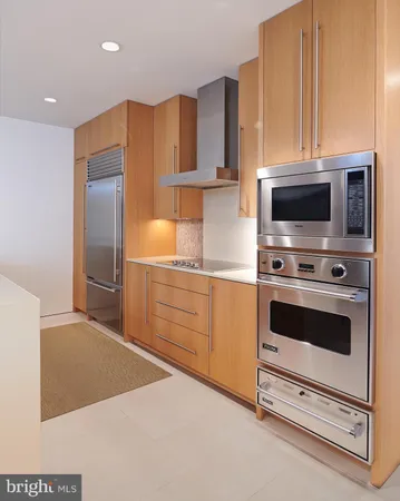 a kitchen with stainless steel appliances a stove a microwave and cabinets