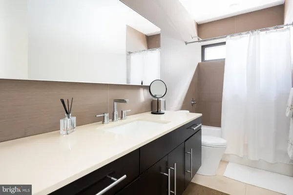 a bathroom with a double vanity sink and a mirror