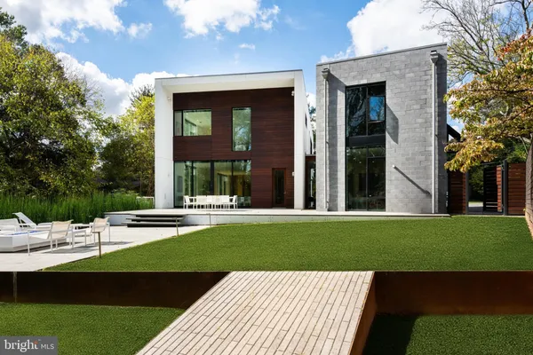 a view of a house with backyard sitting area and garden