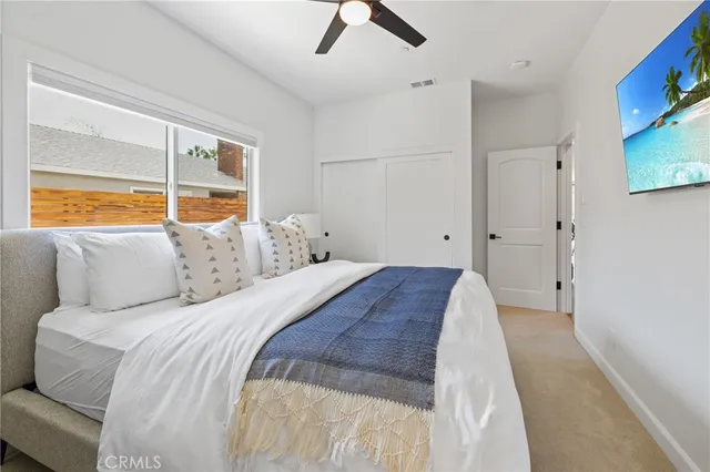 a spacious bedroom with a bed and a large window