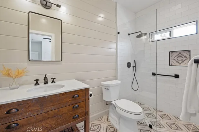 a bathroom with a toilet sink shower and mirror