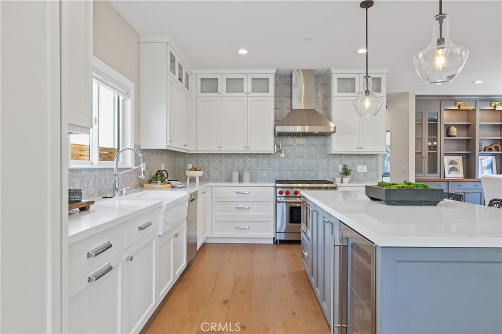 1703 South Ola Vista San Clemente, CA 92672 - Photo 3 of 45 a kitchen that has a lot of cabinets in it and wooden floors