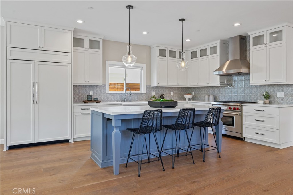 1703 South Ola Vista San Clemente, CA 92672 - Photo 4 of 45 a kitchen with stainless steel appliances granite countertop a stove a sink dishwasher a refrigerator and a dining table with wooden floor