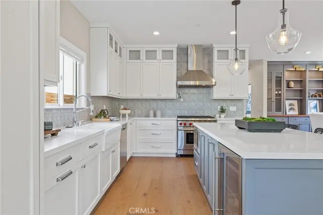 a kitchen that has a lot of cabinets in it and wooden floors