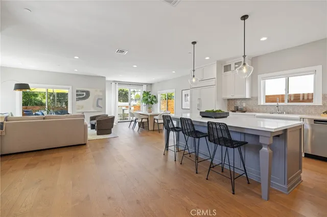a living room with furniture a dining table and chairs