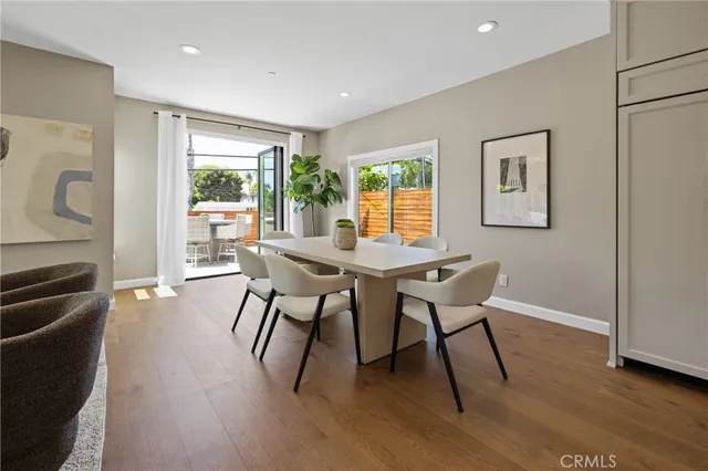 a dining room with furniture and wooden floor