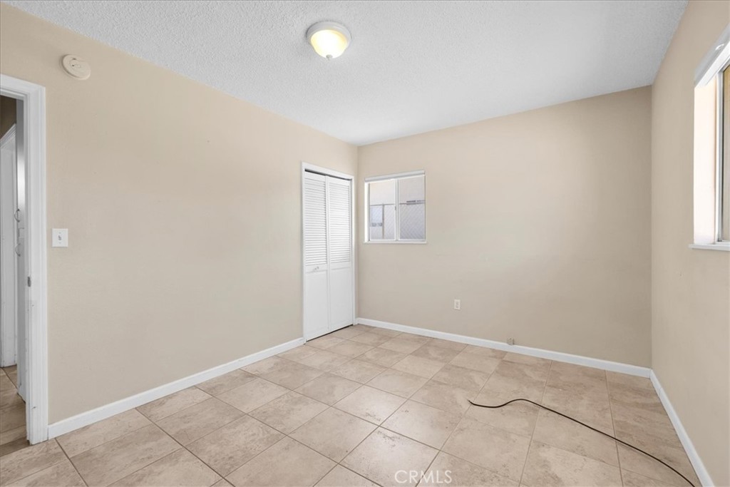 7337 Condalia Avenue Yucca Valley, CA 92284 - Photo 14 of 48 an empty room with windows and closet