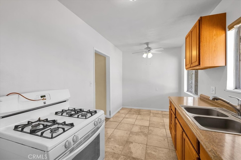7337 Condalia Avenue Yucca Valley, CA 92284 - Photo 15 of 48 a kitchen with a sink stove and refrigerator