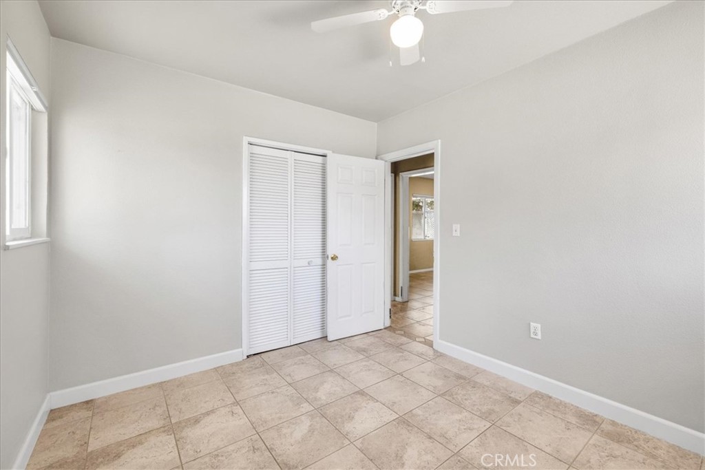 7337 Condalia Avenue Yucca Valley, CA 92284 - Photo 19 of 48 an empty room with a chandelier fan