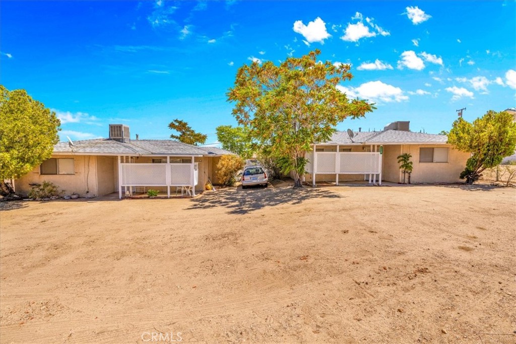 7337 Condalia Avenue Yucca Valley, CA 92284 - Photo 20 of 48 a front view of a house with a yard