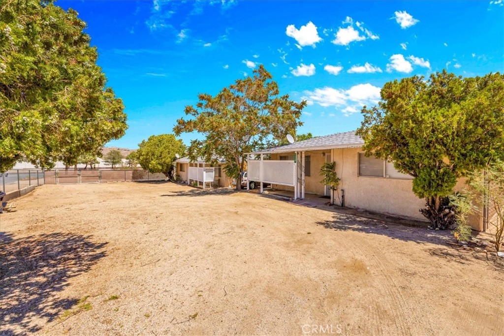 7337 Condalia Avenue Yucca Valley, CA 92284 - Photo 24 of 48 a view of a house with a yard