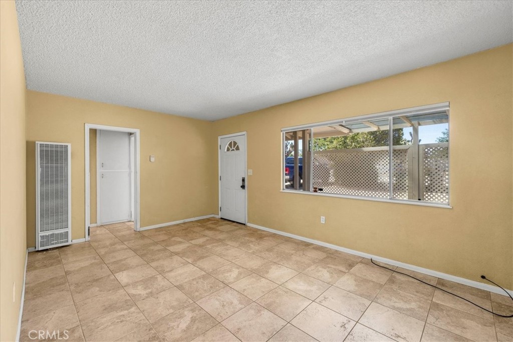 7337 Condalia Avenue Yucca Valley, CA 92284 - Photo 5 of 48 a view of empty room with wooden floor and fan