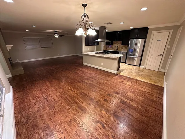 a kitchen with granite countertop stainless steel appliances and wooden cabinets