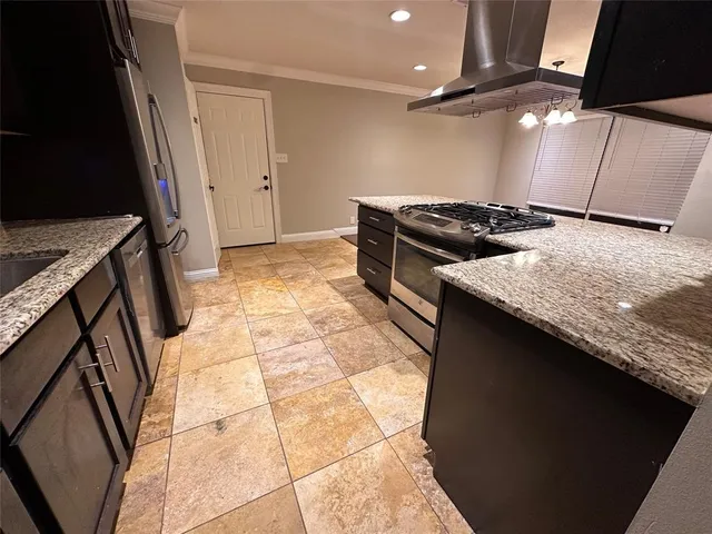 an empty room with wooden floor a ceiling fan and windows