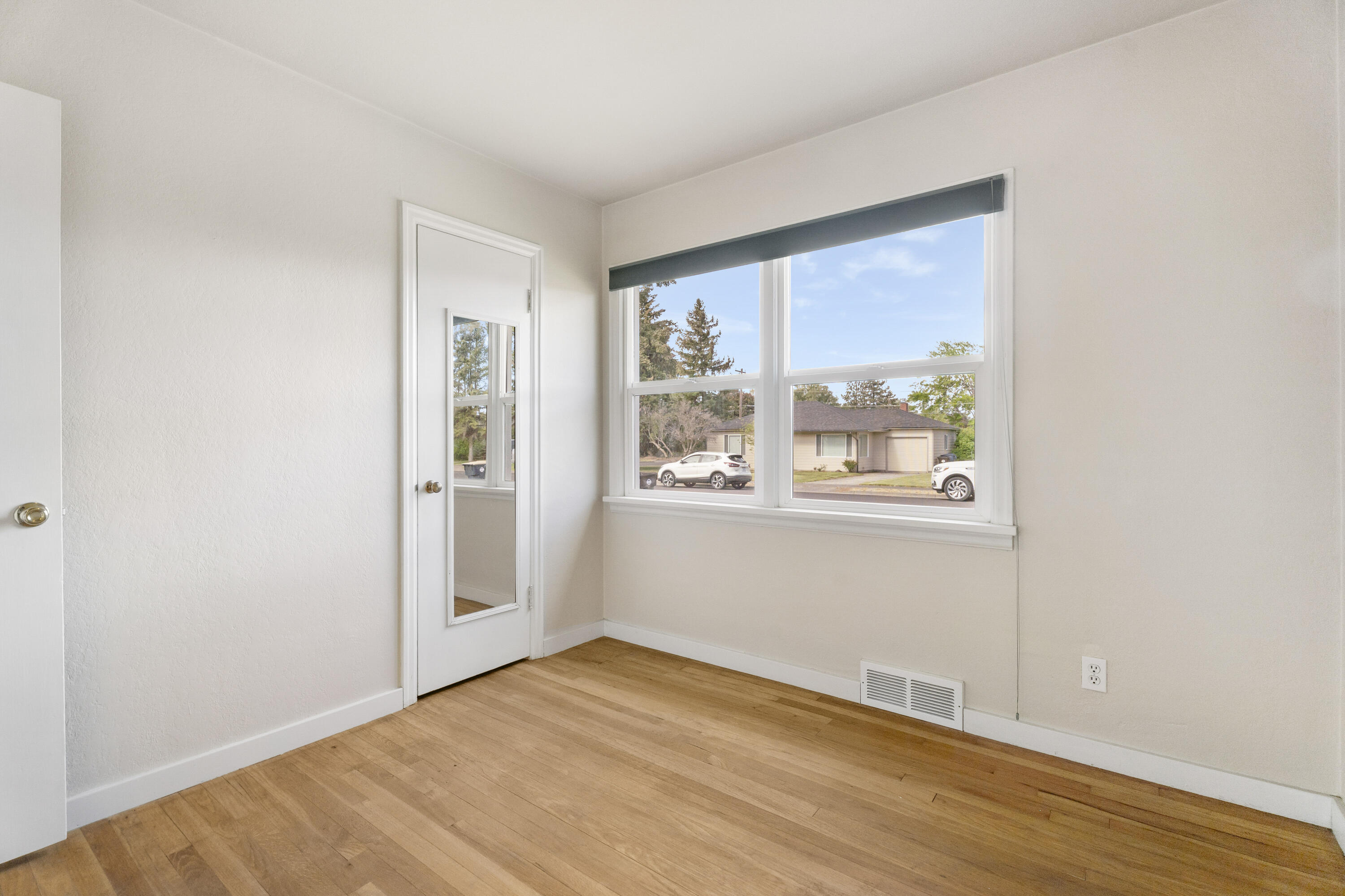 946 Southwest 13th Street Redmond, OR 97756 - Photo 30 of 49 a view of an empty room with wooden floor and a window