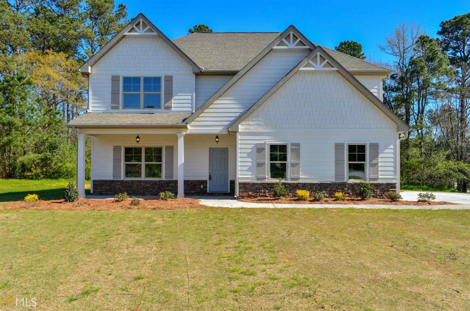 66 Bottoms Road, Unit 7 Concord, GA 30206 - Photo 1 of 1 a front view of a house with a yard and trees