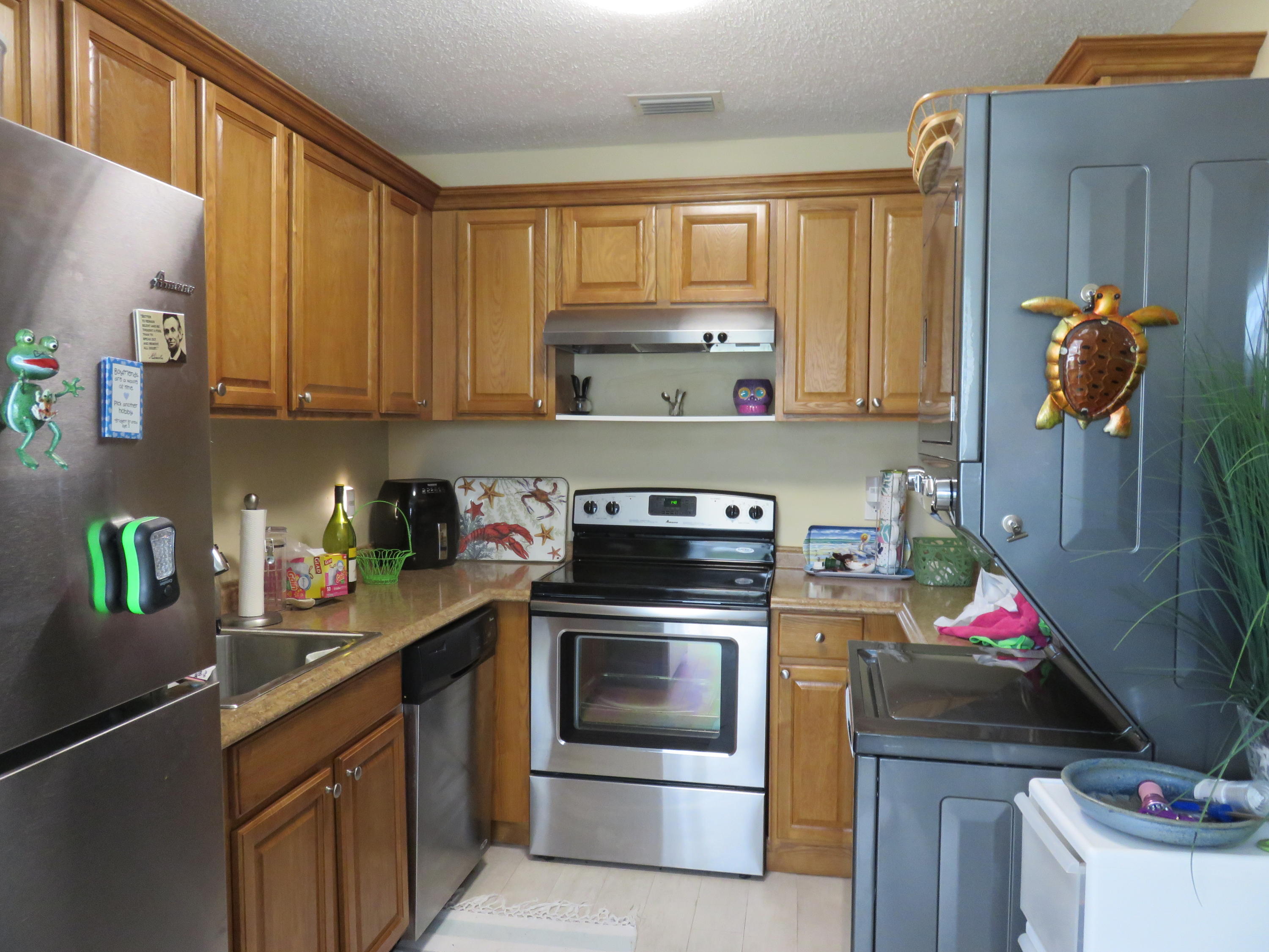8697 Boca Drive Boca Raton, FL 33433 - Photo 2 of 8 a kitchen with a stove top oven and cabinets