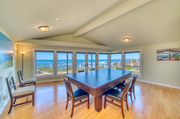 a dining room with furniture and wooden floor