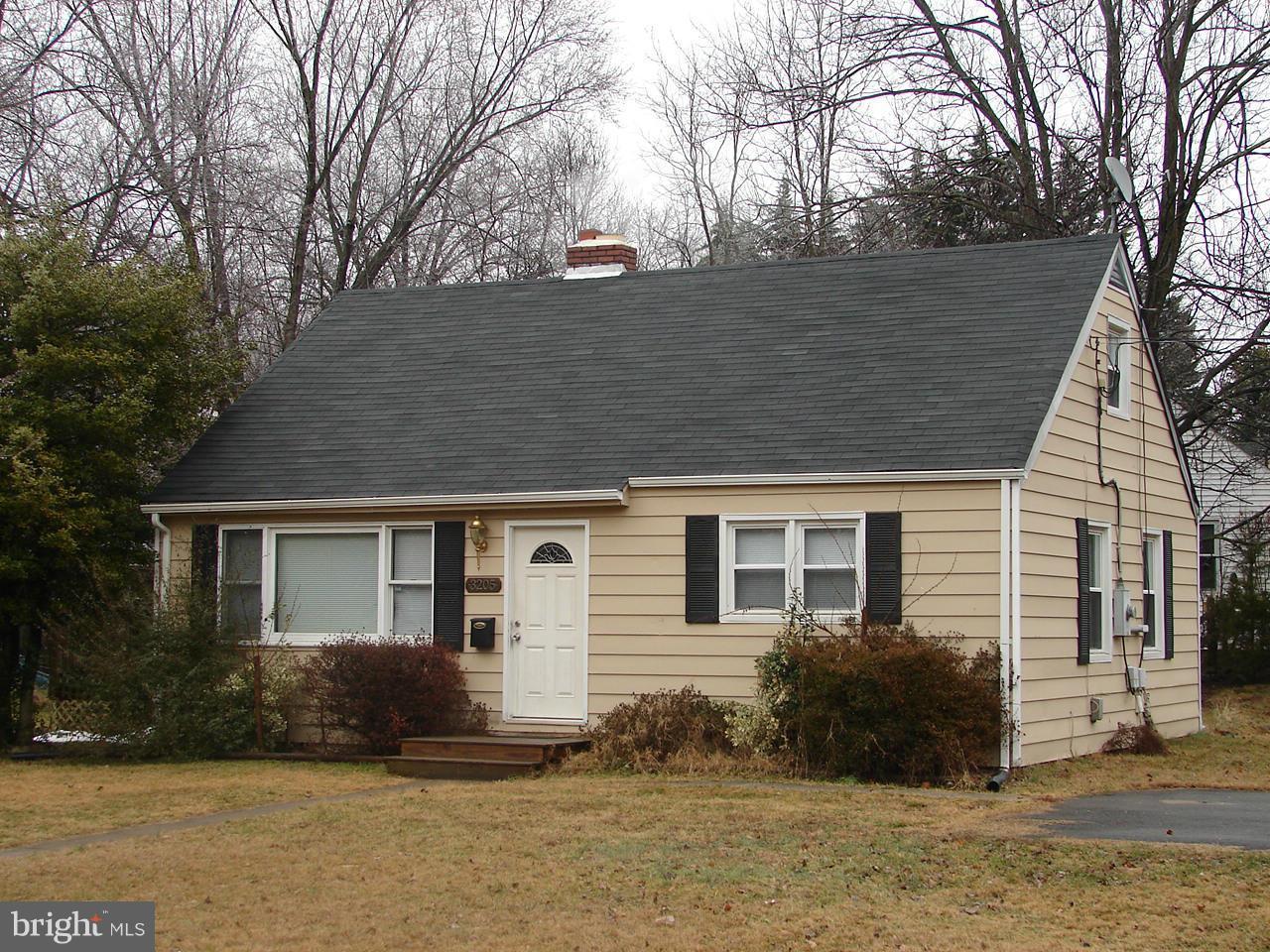 a backyard of a house with large trees and barbeque oven