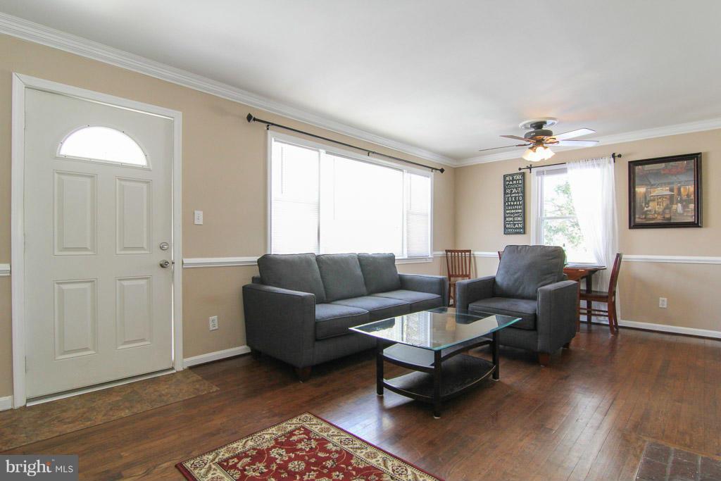 3205 Holloway Road Falls Church, VA 22042 - Photo 2 of 30 a living room with furniture a chandelier and a window