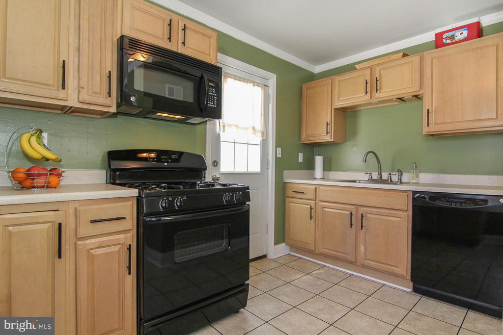3205 Holloway Road Falls Church, VA 22042 - Photo 7 of 30 a kitchen with cabinets stainless steel appliances and a sink