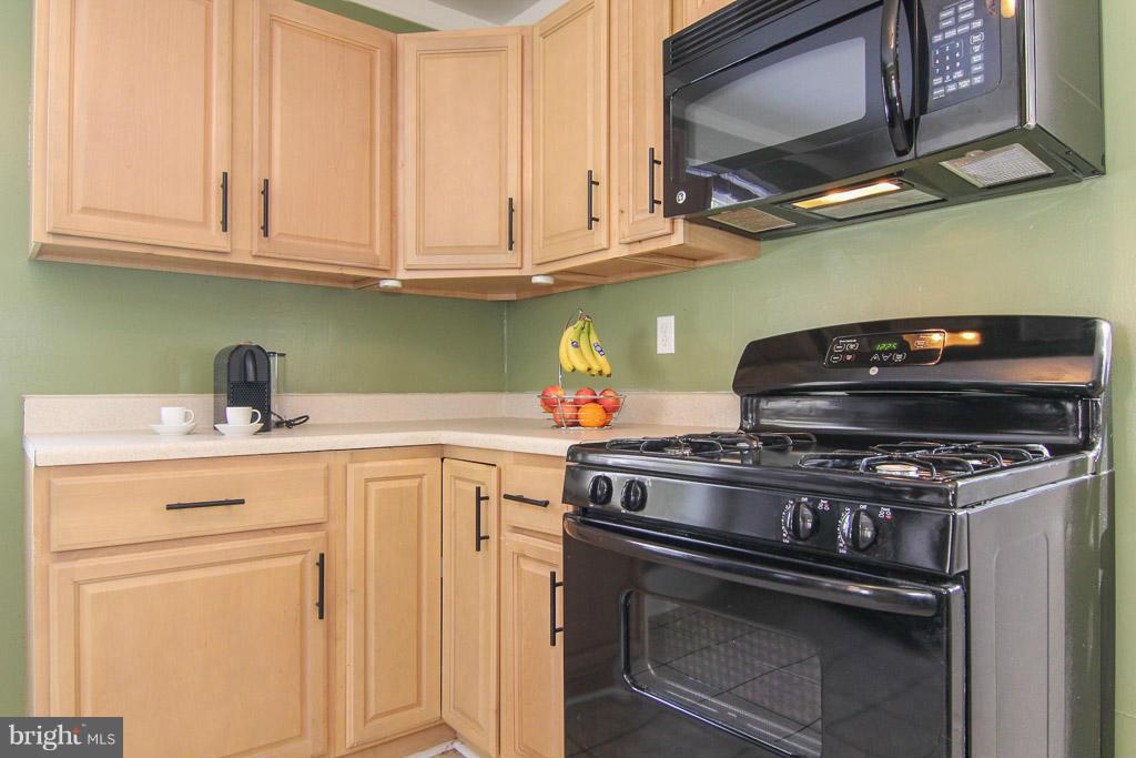 3205 Holloway Road Falls Church, VA 22042 - Photo 8 of 30 a kitchen with stainless steel appliances granite countertop a stove a microwave and cabinets