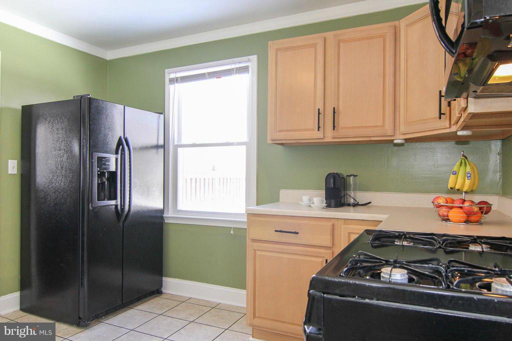 3205 Holloway Road Falls Church, VA 22042 - Photo 10 of 30 a kitchen with stainless steel appliances granite countertop a refrigerator and a stove top oven