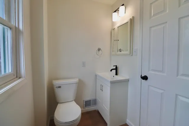 a white toilet sitting next to a bathroom sink