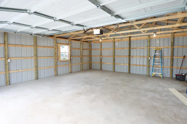 a view of a house with backyard and trees