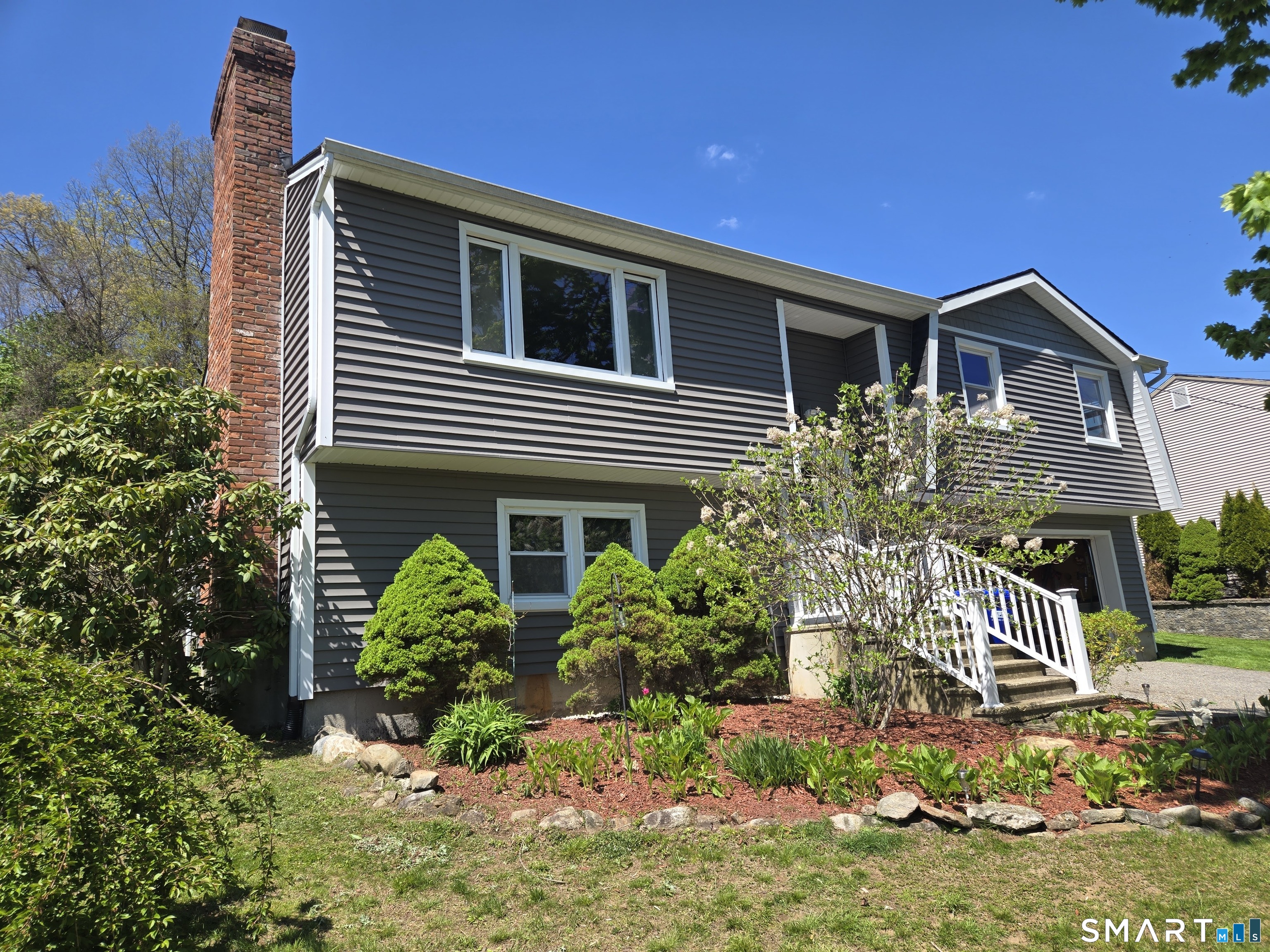 1004 Hickory Hill Road Thomaston, CT 06787 - Photo 2 of 23 a front view of a house with a yard
