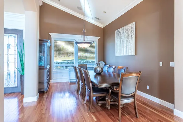 a view of a dining room with furniture and wooden floor