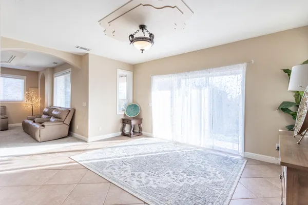a spacious bedroom with a bed and a chandelier