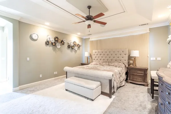 a bedroom with a bed and a chandelier