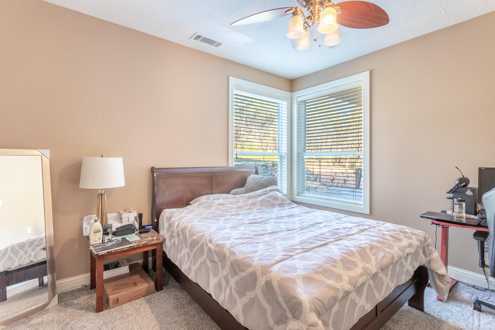 7775 Muletown Road Redding, CA 96001 - Photo 27 of 45 a bedroom with a bed and a chandelier