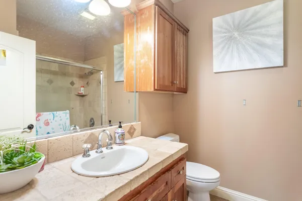 a bathroom with a sink a toilet and a mirror