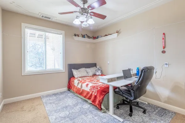 a bedroom with a bed and a chandelier